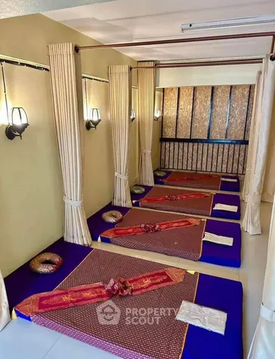 Serene massage room with traditional mats and ambient lighting, perfect for relaxation and wellness.