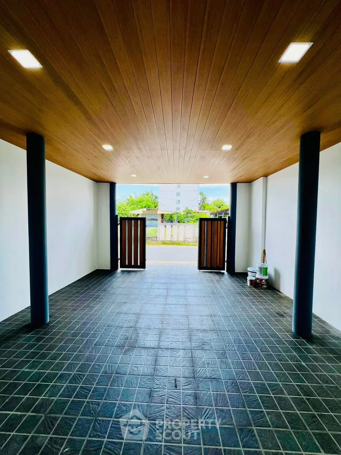 Spacious modern garage with wooden ceiling and tiled floor, perfect for secure parking.