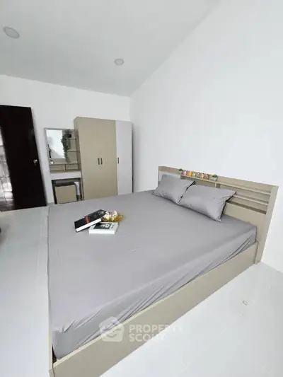 Spacious bedroom with modern furnishings and neutral decor, perfect for relaxation and comfort.