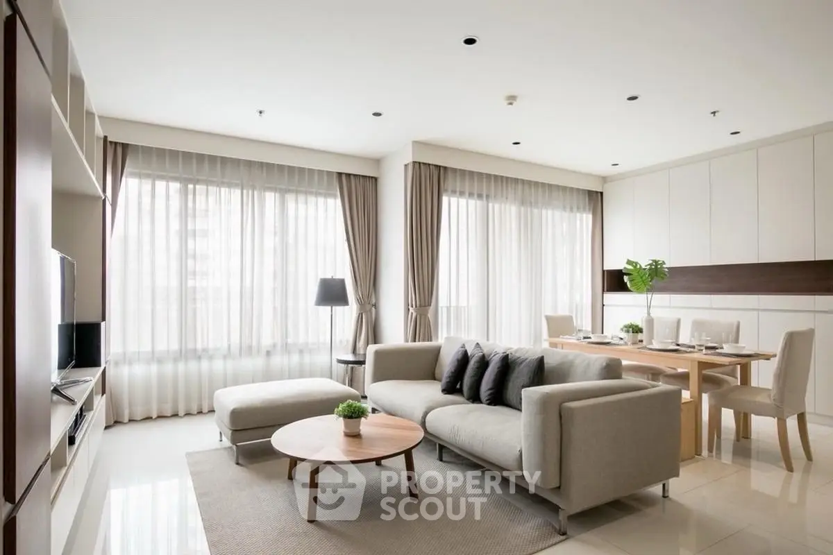 Spacious modern living room with elegant decor and large windows for natural light.