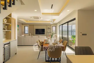 Luxurious open-plan living and dining area with modern decor and ample natural light.