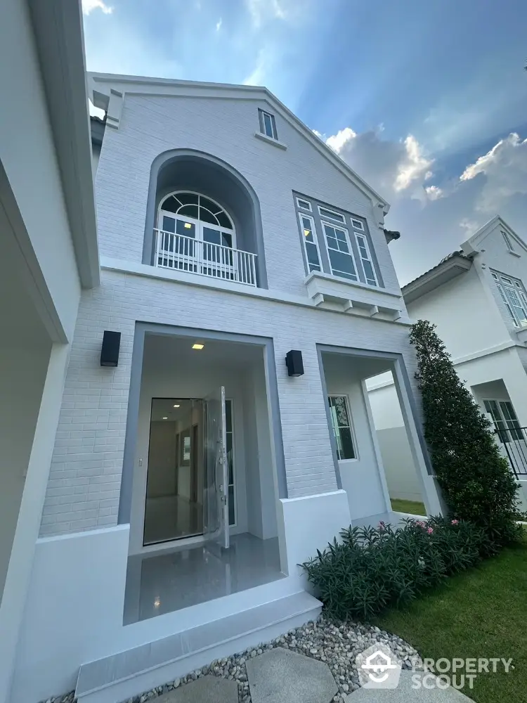 Stunning modern white brick house with elegant entrance and lush garden