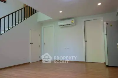 Spacious modern living room with wooden flooring and air conditioning