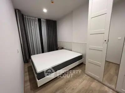 Modern minimalist bedroom with sleek design and ample natural light.