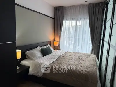 Cozy bedroom with modern decor and large window for natural light