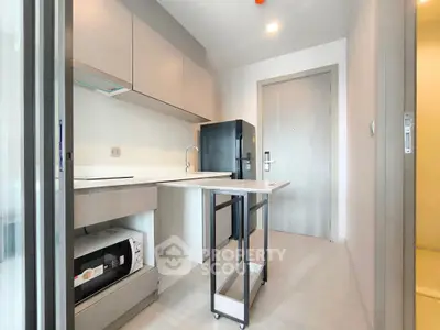 Modern kitchen with sleek cabinetry and compact layout