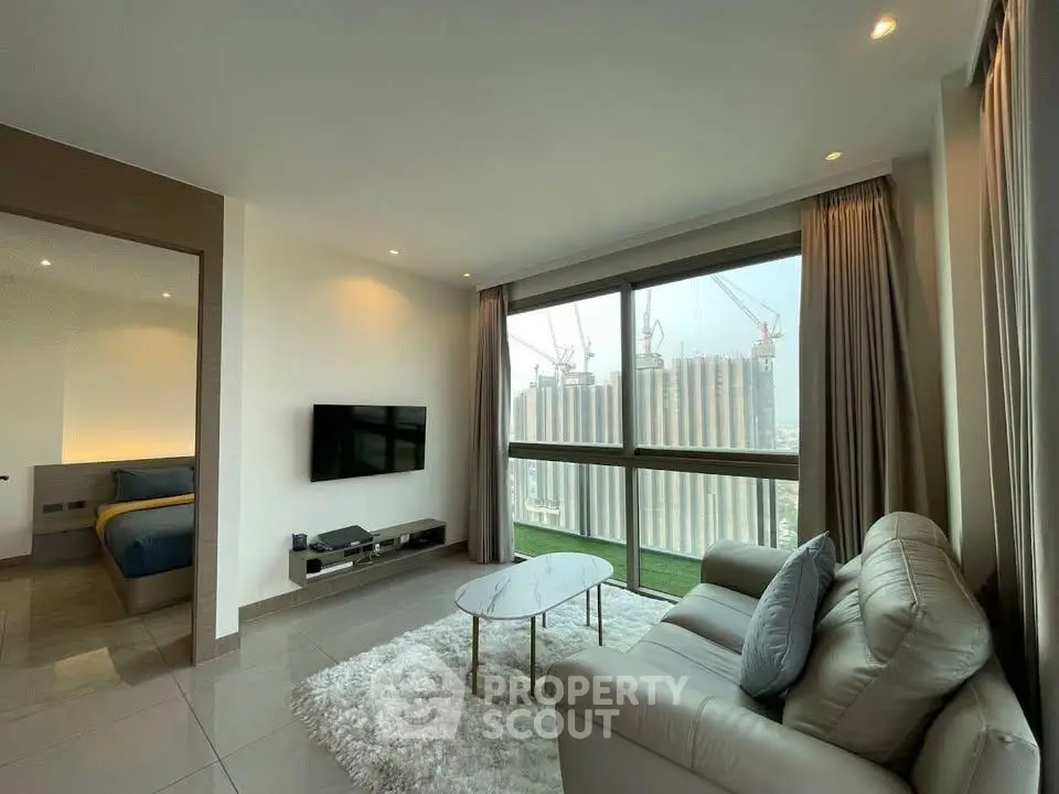 Modern living room with city view, featuring sleek furniture and large windows.