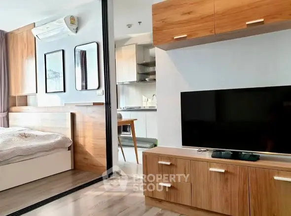 Modern studio apartment with wooden furniture and open kitchen layout