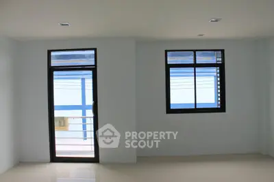 Spacious room with large windows offering ample natural light and modern design.