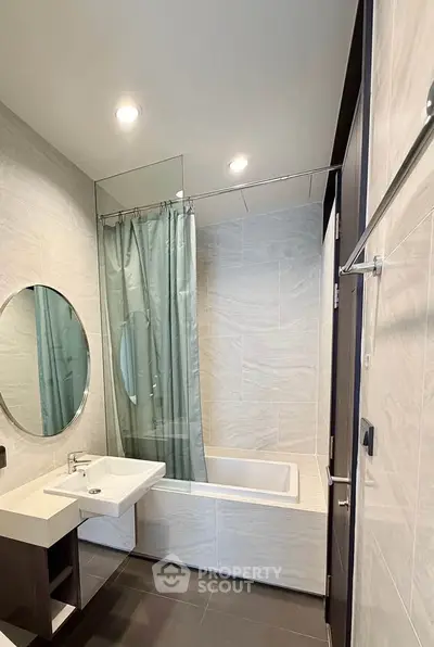 Modern bathroom with bathtub and sleek design in a contemporary apartment.