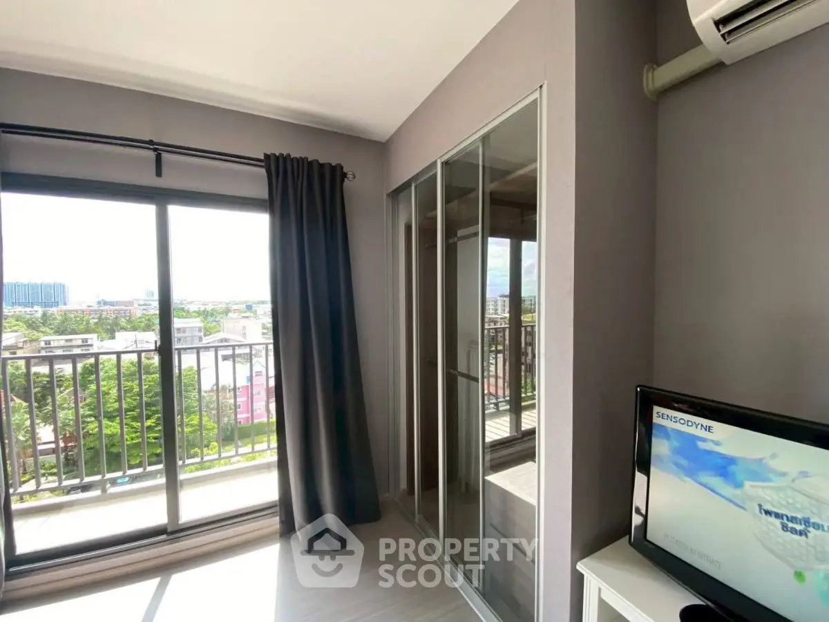 Modern apartment with balcony and air conditioning, featuring a sleek design and ample natural light.