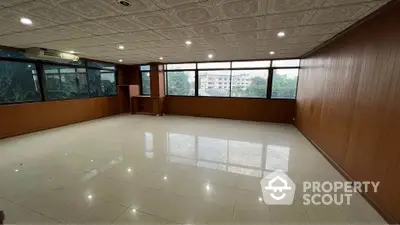 Spacious office space with large windows and tiled flooring, ideal for business setup.