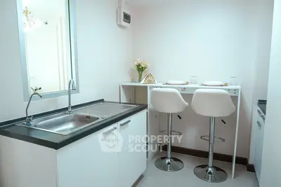 Modern kitchen with sleek design and breakfast bar seating