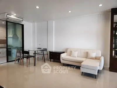 Modern living room with sleek furniture and open kitchen layout