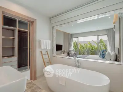 Luxurious bathroom with freestanding bathtub and garden view in modern home