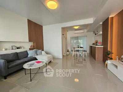 Modern living room with sleek design and open layout, featuring cozy seating and stylish decor.