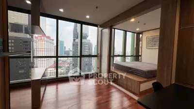 Modern bedroom with stunning city view and wooden flooring