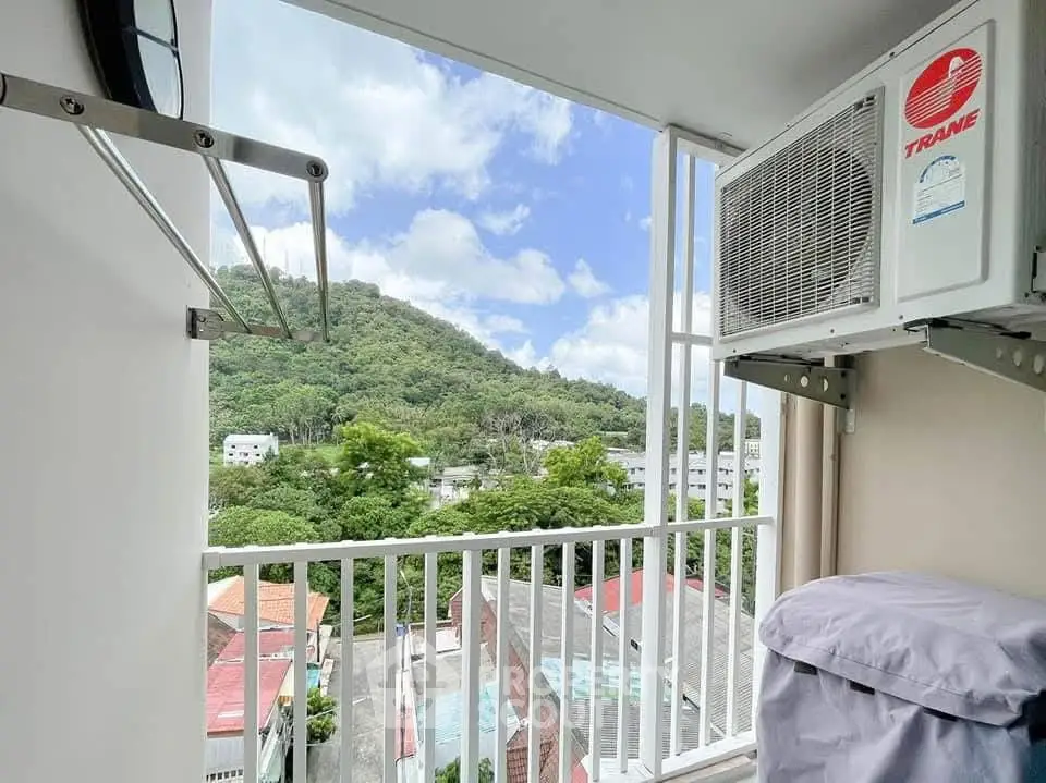 Stunning balcony view with lush greenery and modern air conditioning unit.