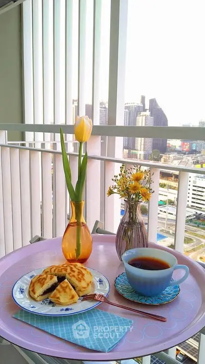 Charming balcony with city view, perfect for morning coffee and relaxation.