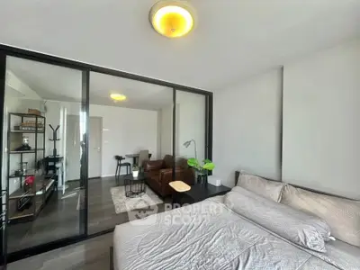 Modern bedroom with glass partition and cozy living area