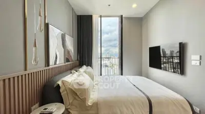 Modern bedroom with city view, stylish decor, and large window for natural light.