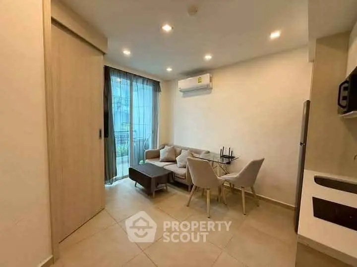 Modern living room with dining area and air conditioning in a cozy apartment.
