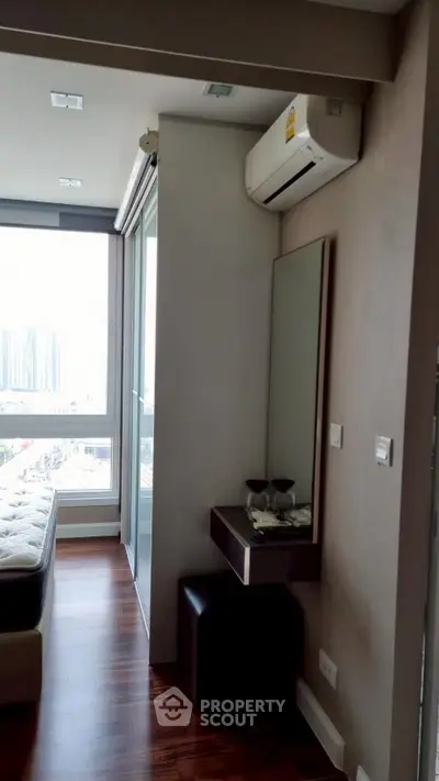 Modern bedroom with large window and air conditioning unit