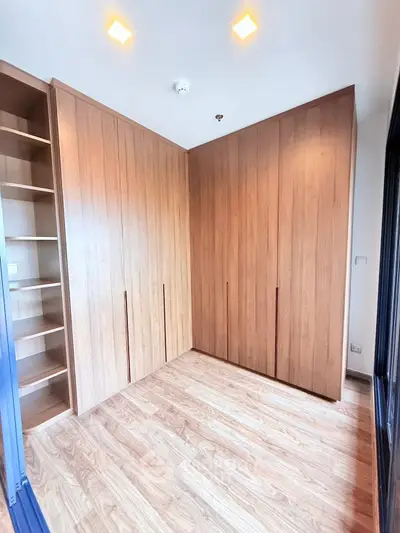 Spacious room with wooden flooring and built-in wardrobes, perfect for storage solutions.