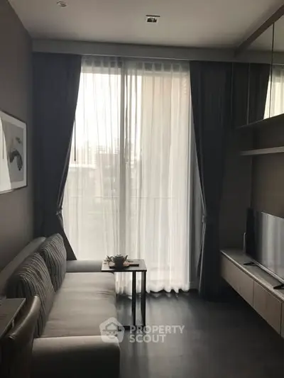 Modern living room with large window and stylish furniture