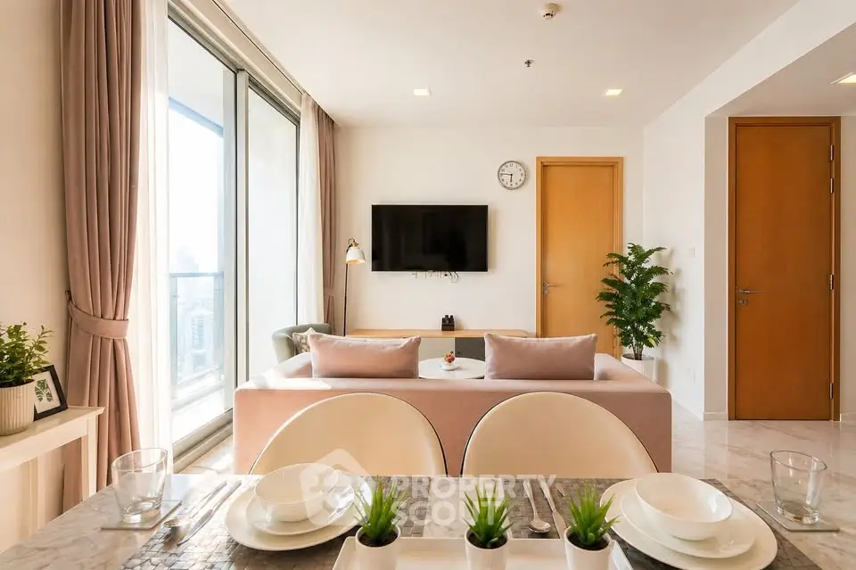 Modern living room with open layout and city view, featuring stylish decor and natural light.