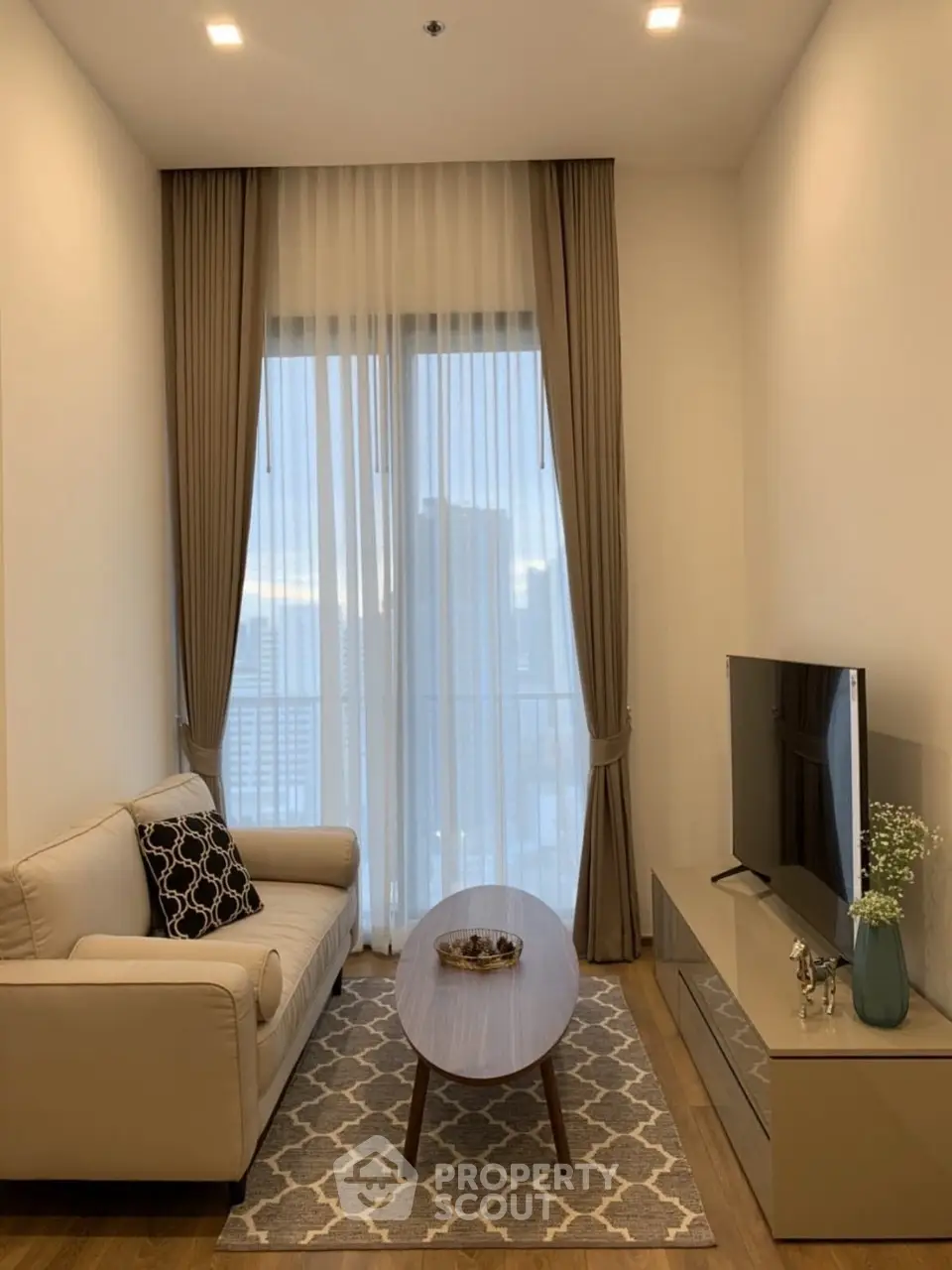 Cozy modern living room with elegant decor and city view.