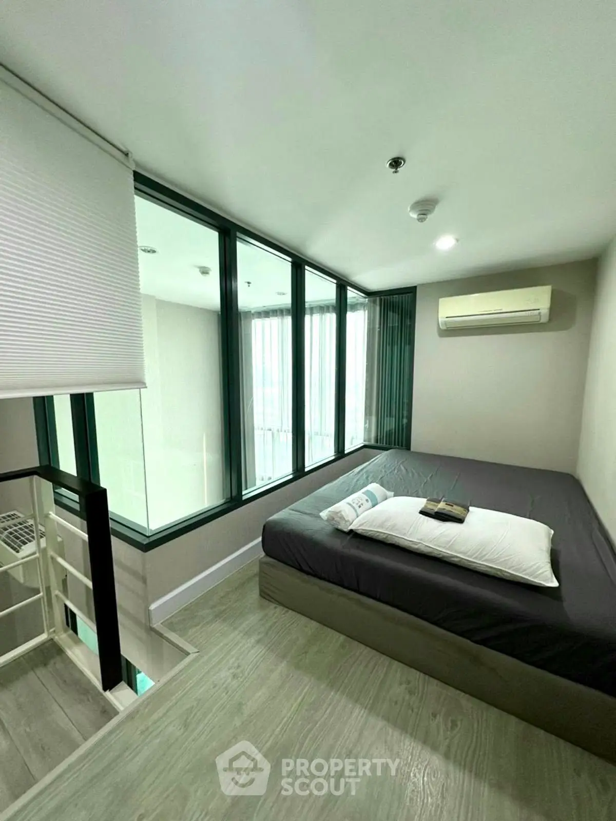 Modern bedroom with large windows and minimalist design