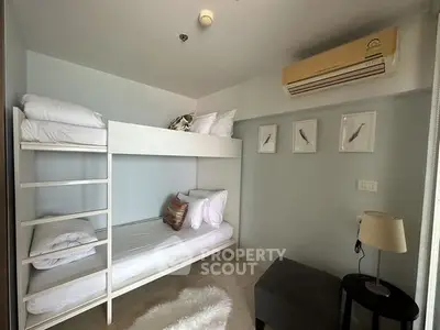 Cozy bedroom with bunk beds and air conditioning in modern apartment.