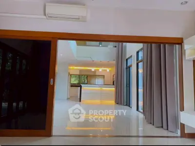 Spacious modern living room with open layout and elegant lighting, perfect for entertaining.