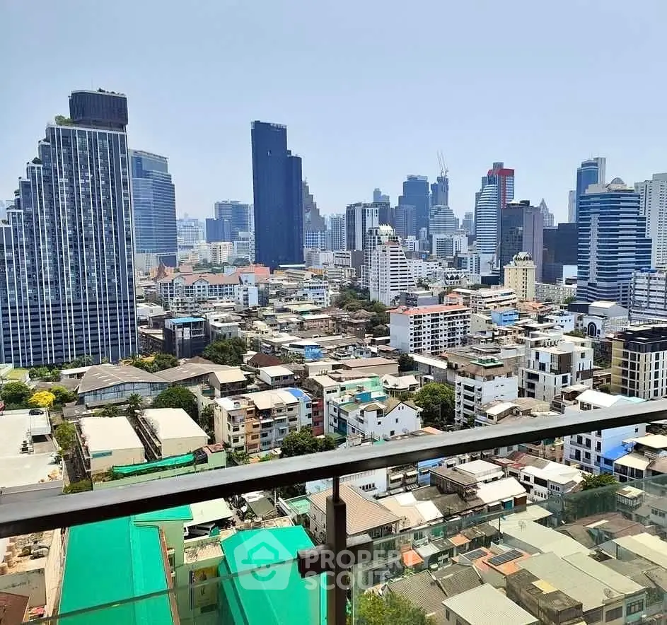 Stunning cityscape view from a high-rise balcony showcasing urban skyline and modern architecture.