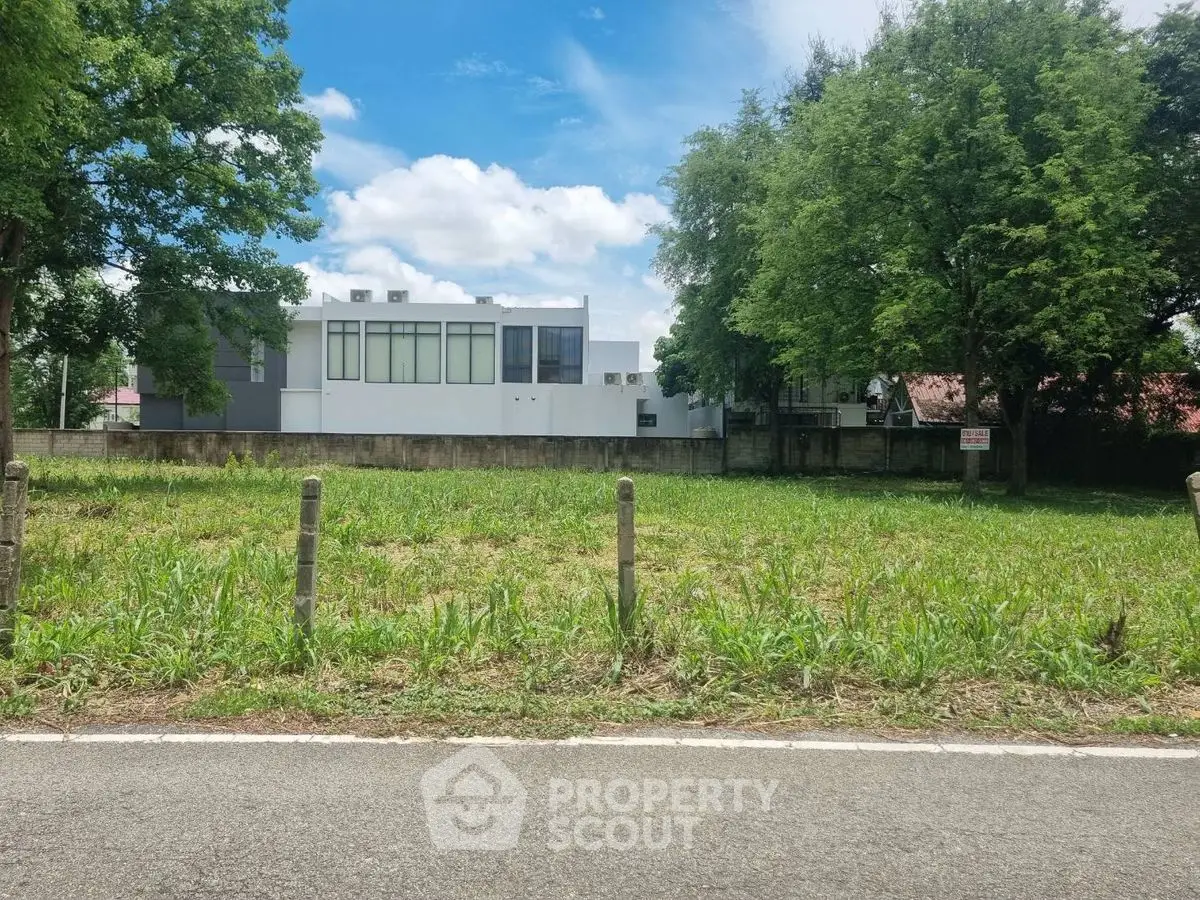 Modern building with lush greenery and clear blue sky, perfect for serene living.