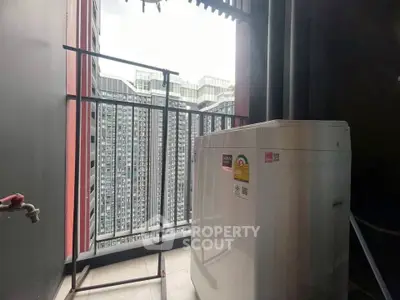 Compact balcony with washing machine and city view, ideal for urban living.