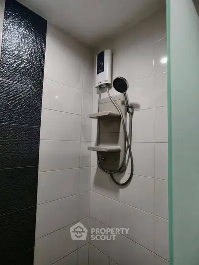 Modern bathroom shower with sleek tiles and water heater