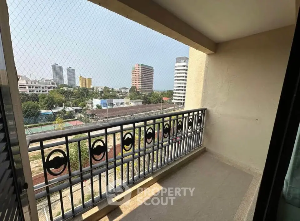 Spacious balcony with city view, perfect for relaxation and enjoying the skyline.