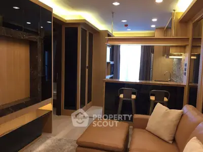 Modern living room with open kitchen and stylish decor in a cozy apartment.