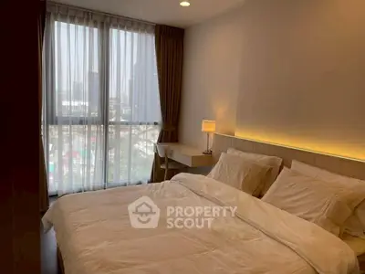 Cozy bedroom with city view, modern furnishings, and ambient lighting.