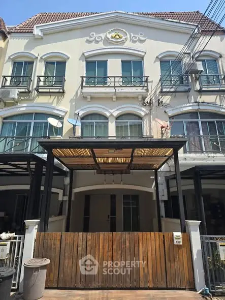 Charming multi-story townhouse with elegant facade and balcony, perfect for urban living.