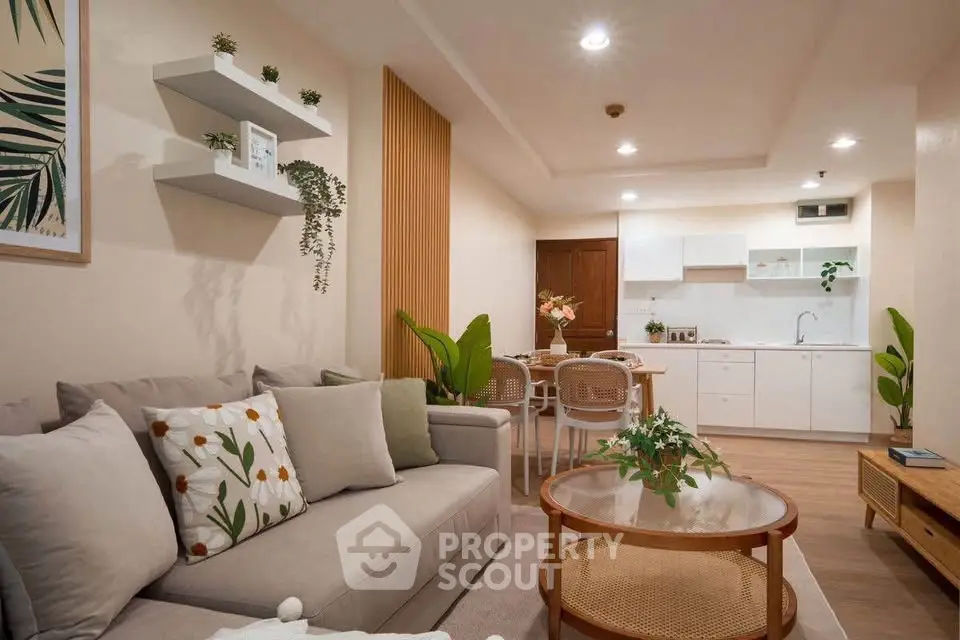 Stylish modern living room with cozy seating and open kitchen layout, perfect for urban living.