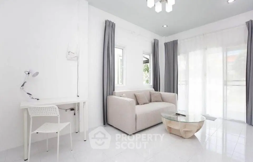 Bright and airy living room with modern furniture and large windows.