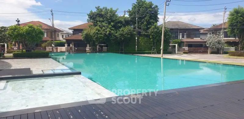 Luxurious residential community with a stunning outdoor pool and modern homes.