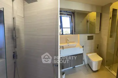 Modern bathroom with sleek shower and elegant fixtures in a contemporary apartment.