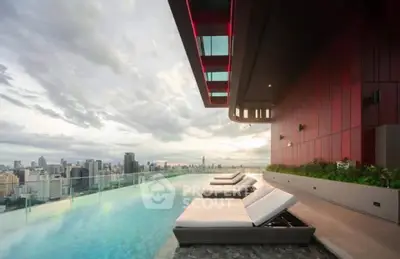 Luxurious rooftop pool with stunning city skyline view and modern lounge chairs.