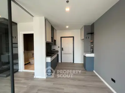 Modern minimalist kitchen with sleek cabinetry and wood flooring