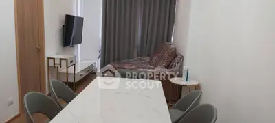 Modern dining area with marble table and cozy living room setup