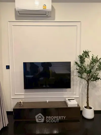 Modern living room with wall-mounted TV and stylish decor